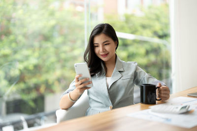 Young businesswoman using mobile phone