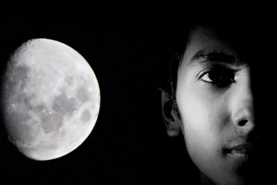 Close-up portrait of man by moon against sky at night