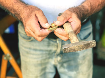Midsection of man working at workshop