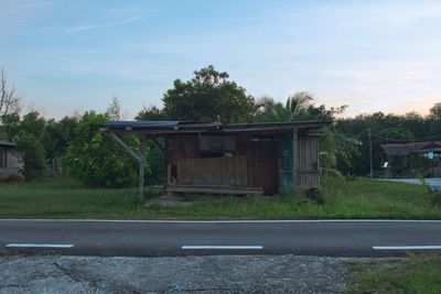 Road by building against sky