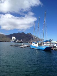 Sailboats sailing in sea against sky