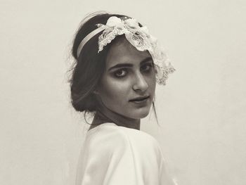 Portrait of a young woman against white background