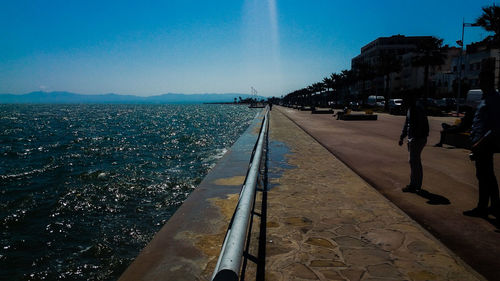 Panoramic view of city by sea against clear sky