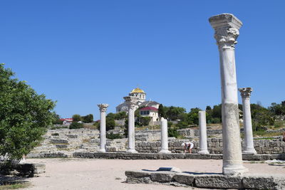 Architectural columns against clear blue sky