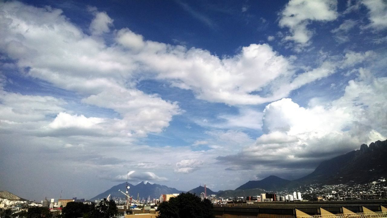 mountain, architecture, built structure, sky, mountain range, cloud - sky, building exterior, cloud, cloudy, city, connection, cityscape, bridge - man made structure, scenics, high angle view, river, nature, day, outdoors, beauty in nature