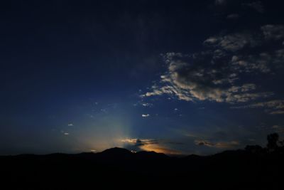 Low angle view of silhouette mountain against sky at night