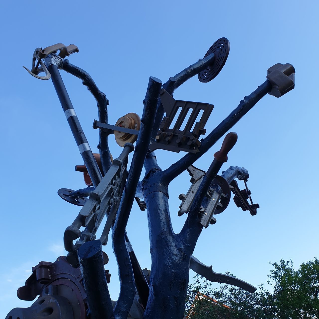 LOW ANGLE VIEW OF MACHINERY AGAINST SKY