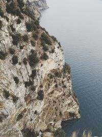 High angle view of rock formation by sea against sky