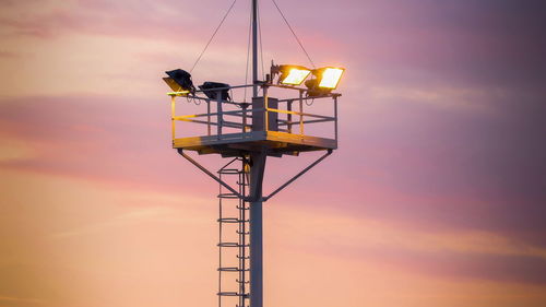 Low angle view of silhouette crane against sky during sunset