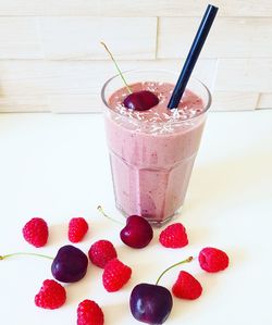 Close-up of strawberry with ice cream on table
