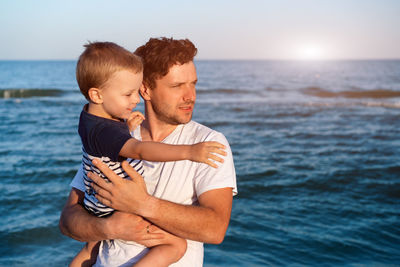 Father and son at sea shore