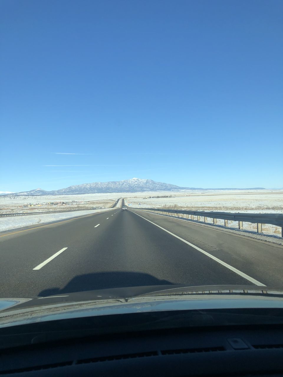 ROAD SEEN THROUGH CAR WINDSHIELD