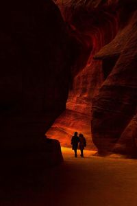 Silhouette of people in cave