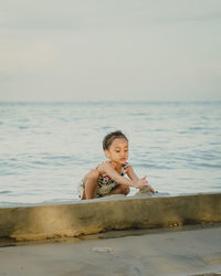 Cute little girl playing in the sand