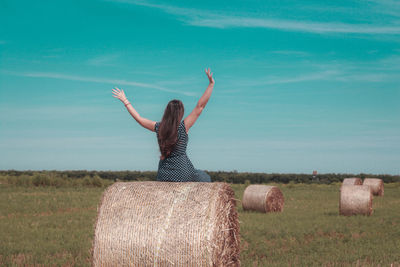 Hay bales on field against sky