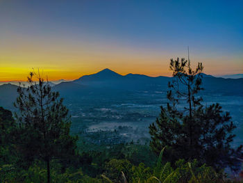 Scenic view of mountains against sky at sunset