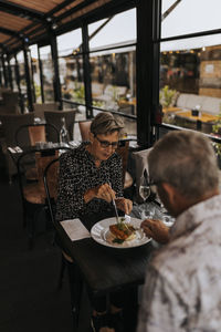 Senior couple sharing food in restaurant