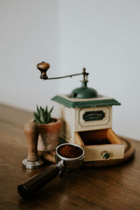 Close-up of pot on table against wall