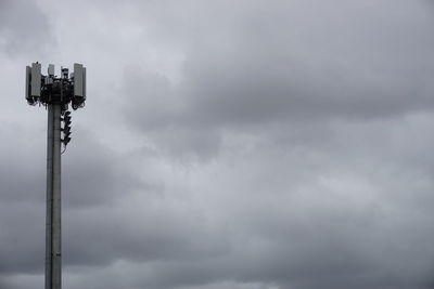 Low angle view of communications tower against sky