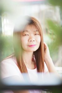 Portrait of mature woman sitting at backyard