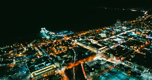 High angle view of illuminated city buildings at night