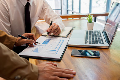 Low angle view of man using laptop on table