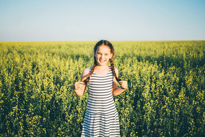 Young woman standing on field