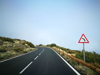 Road sign against clear sky