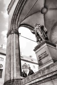 Low angle view of statue against sky in city