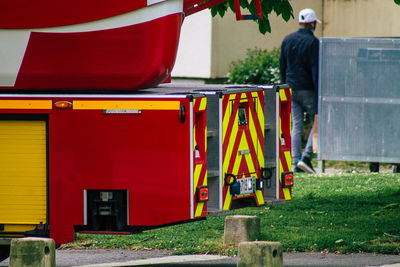 Rear view of people working on red truck