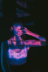 Portrait of young woman in darkroom