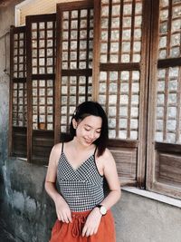 Portrait of smiling young woman sitting outdoors