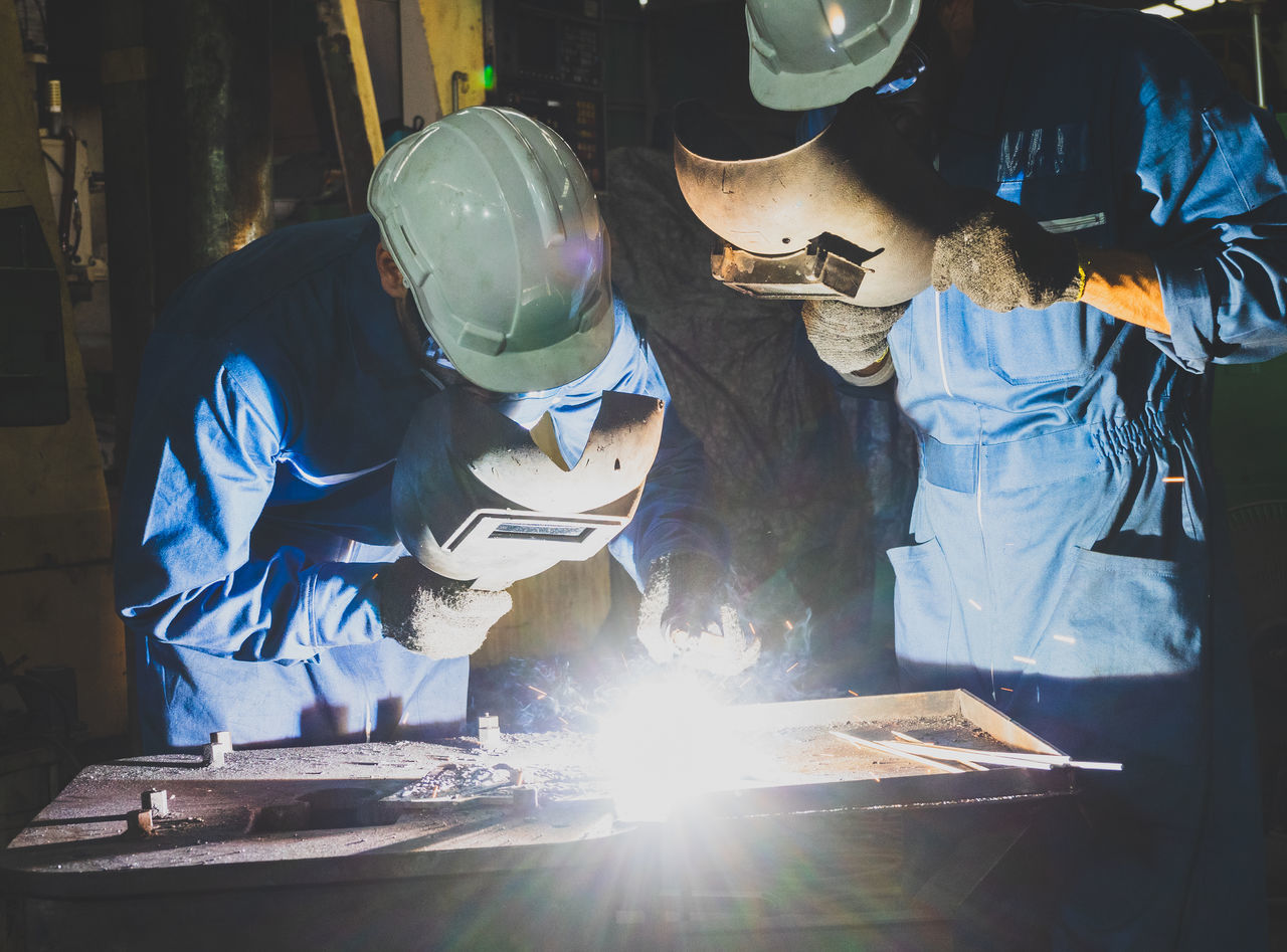 MAN WORKING ON METAL