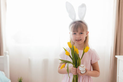 Portrait of smiling girl standing at home