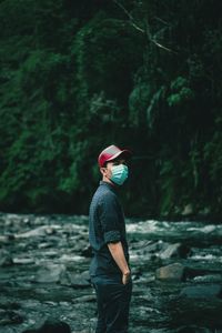 Rear view of man standing in forest