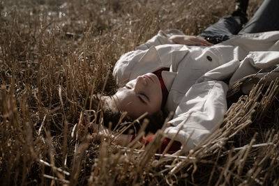 Young woman sleeping on field