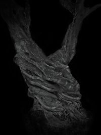 Close-up of woman with hand in black background