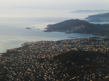 Aerial view of sea and mountains against sky