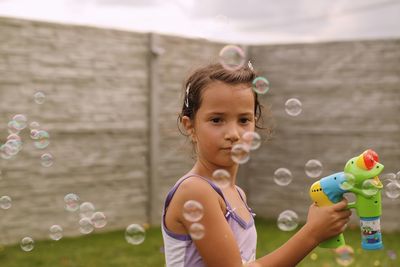 Girl playing with bubbles