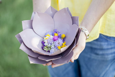 Midsection of woman with flowers