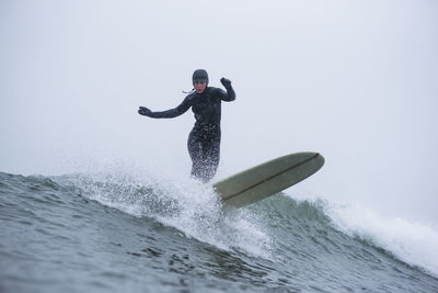 Woman surfing during winter snow