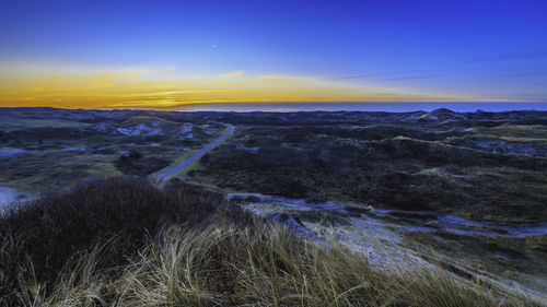 Scenic view of landscape against sky during sunset