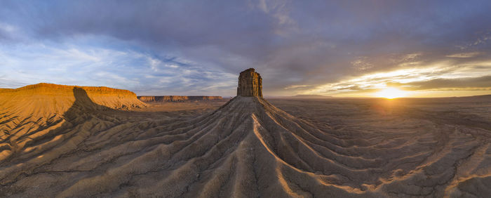 Erosion cuts deep lines in the earth surround the chimney rock m