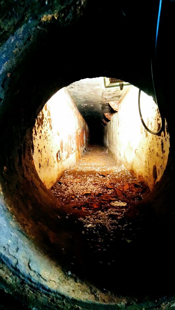 HIGH ANGLE VIEW OF ILLUMINATED TUNNEL SEEN THROUGH ARCH