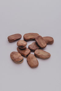 High angle view of coffee beans against white background