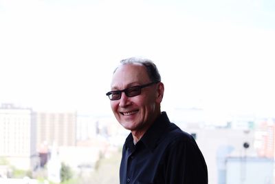 Portrait of smiling young man against sky