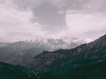 Scenic view of mountains against cloudy sky