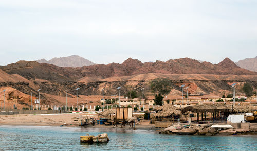 Panoramic view of buildings and mountains against sky