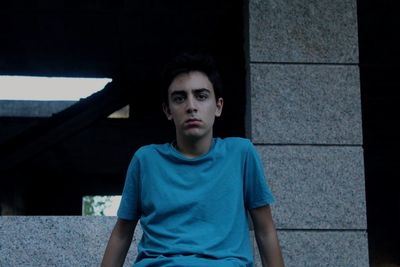 Portrait of teenage girl sitting outdoors