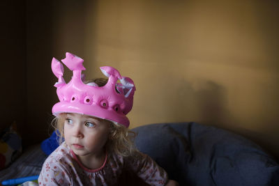 Cute girl wearing headwear at home